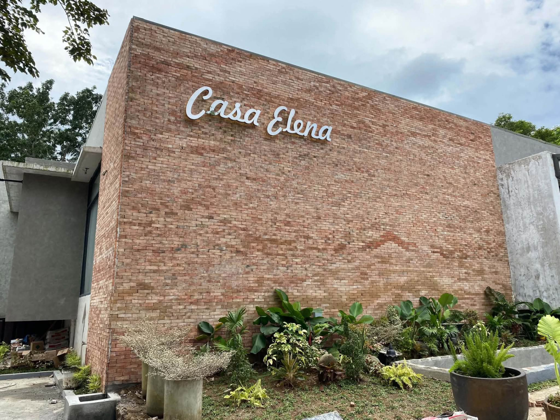 The Casa Elena brick wall with its white sign